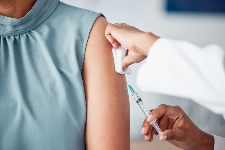 Nurse Administering Injection on Patient's Upper Left Arm