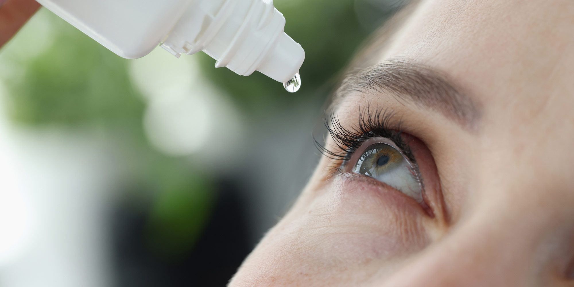 eyedrops being squeezed into eye